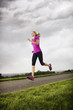 Foto: Female Runner working out dramatic clouds Female Runner working out dramatic clouds