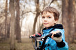 Photo: Portrait of serious boy with bicycle in park Portrait of serious boy with bicycle in park