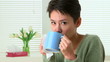 Woman sick with flu sneezing and drinking tea