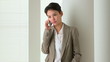 Happy Asian business woman talking on mobile phone