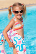 little girl in the swimming pool  with rubber ring