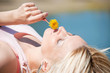 Photo: Woman smelling yellow dandelion Woman smelling yellow dandelion