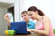 couple buying online with laptop