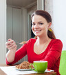 Happy girl eats buckwheat