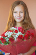 smiling little girl with bouquet of roses