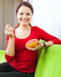  young woman eats grapefruit with spoon