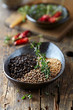 Photo: Assorted spices and fresh thyme in a ceramic dish Assorted spices and fresh thyme in a ceramic dish
