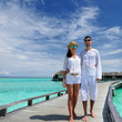 Couple on a beach jetty at Maldives