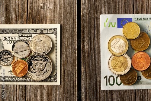Photo: US and euro money over wooden background US and euro money over wooden background