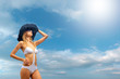 Bikini model over sky background