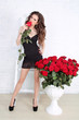 Sexy brunette woman with Red roses at home interior apartment