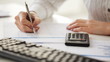 accountant making calculations and taking notes