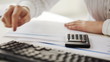 accountant making calculations and working with computer