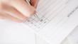 hands filling checklist and answering with yes