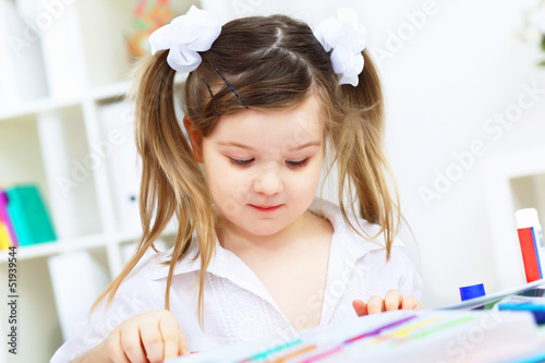 Photo: Little girl studying Little girl studying