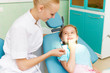 Foto: Little girl visiting dentist Little girl visiting dentist