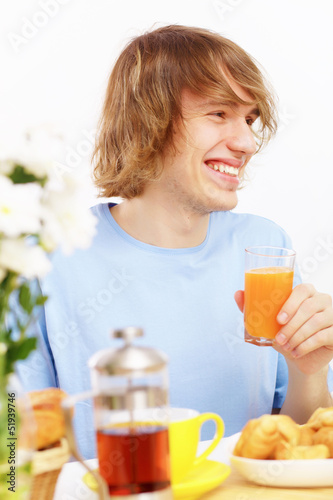 Photo: Young man drinking juice Young man drinking juice