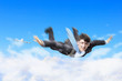 Young businessman flying with parachute on back