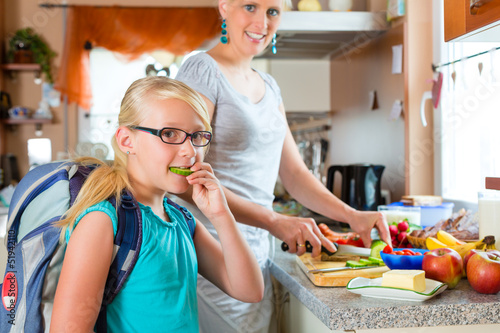 Photo: Family - mother making breakfast for school Family - mother making breakfast for school