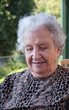 Photo: portrait of a happy old woman against natural background portrait of a happy old woman against natural background