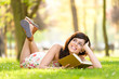 woman reading book and day dreaming