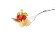Spaghetti pasta with tomato sauce and basil on fork