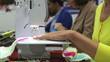 Close Up Of Woman Sewing Using Electric Machine