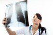 Female doctor examining an x-ray image. Focus on face