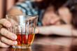 Foto: Asleep drunk woman holding an alcoholic drink Asleep drunk woman holding an alcoholic drink