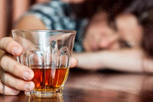 Photo: Asleep drunk woman holding an alcoholic drink Asleep drunk woman holding an alcoholic drink