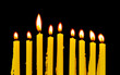 yellow candles isolated on black background