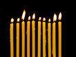yellow candles isolated on black background