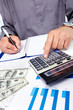 Hands of businessman with calculator.