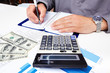 Hands of businessman with calculator.
