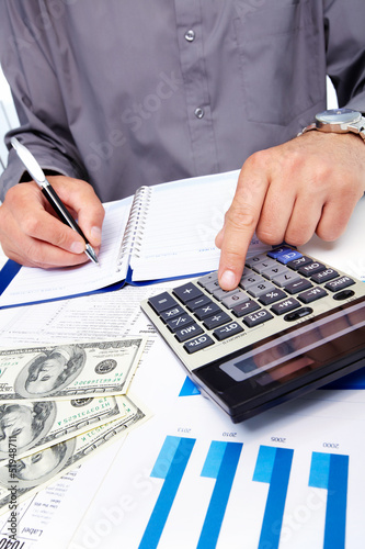 Photo: Hands of businessman with calculator. Hands of businessman with calculator.