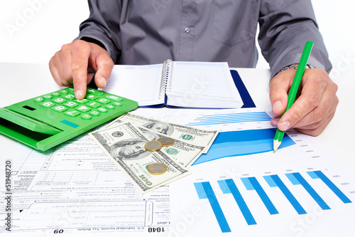 Photo: Hands of businessman with calculator. Hands of businessman with calculator.