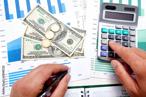 Photo: Hands of businessman with calculator. Hands of businessman with calculator.