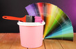 Paint pot, paintbrush and coloured swatches