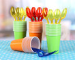 Cups, spoons and forks, of different colors on bright