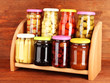 Different conservations on shelves on wooden background