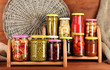 Different conservations on shelves on wooden background