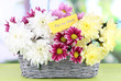 Bouquet of beautiful chrysanthemums in wicker basket