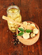 Mushrooms in bowl, on wooden background