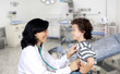 Photo: Brunette pediatrician at the hospital with a baby Brunette pediatrician at the hospital with a baby