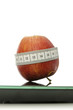 Apple wrapped with measuring tape on a scale