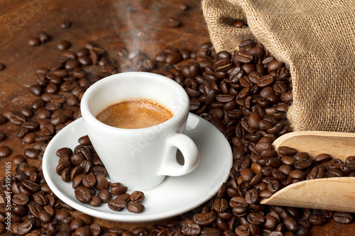 Photo: coffee cup with burlap sack of roasted beans coffee cup with burlap sack of roasted beans