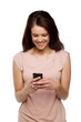 Brunette woman texting on a mobile phone