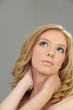 Closeup of a pretty woman holding her neck