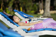 Attractive woman sunbathing at beach resort