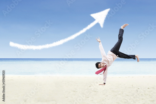 Photo: Businessman dance and increase arrow sign cloud at beach Businessman dance and increase arrow sign cloud at beach